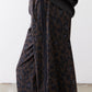 Draped dark leopard print fabric on loose work pants with gathered waist knot