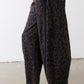 Loose leopard print work pants with draped fabric and straight hems at ankles