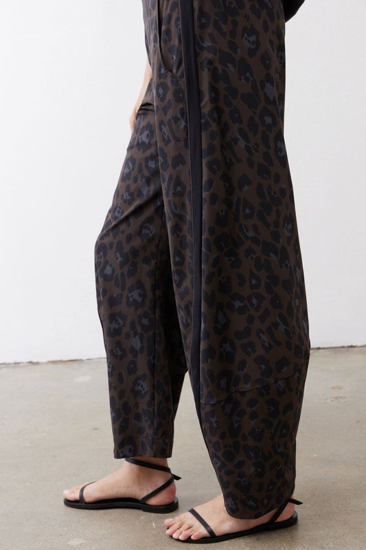 Loose leopard print work pants with draped fabric and straight hems at ankles