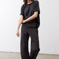Loose work pants in dark leopard print with elastic waist and relaxed ankle-length fit