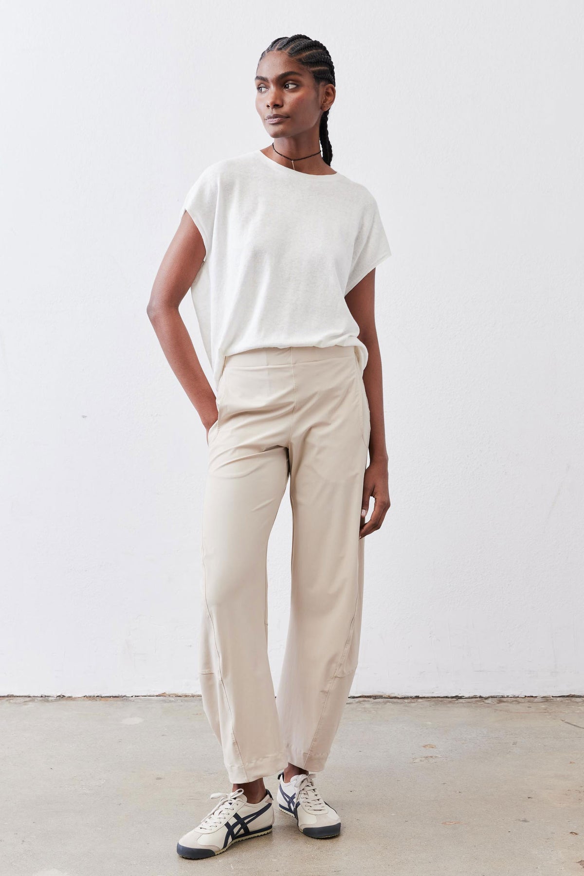 Light beige loose work pants with relaxed rise, straight legs, and ankle hem