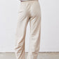 Light beige elastic-waist work pants with straight legs and gathered back