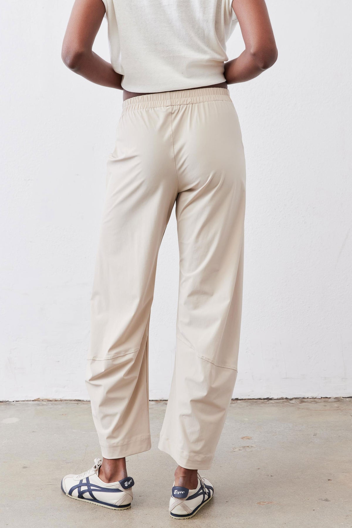 Light beige elastic-waist work pants with straight legs and gathered back