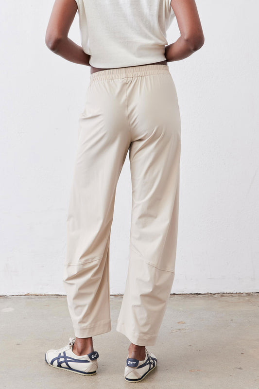 Light beige elastic-waist work pants with straight legs and gathered back