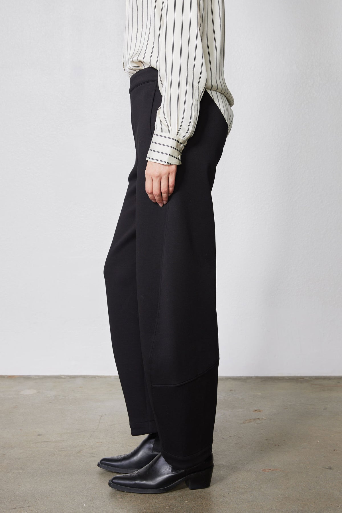 Black work scuba pants side view with wide-leg drape and ankle hem