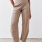 Tan work pants close-up showing relaxed fit, elastic waistband, and tapered leg