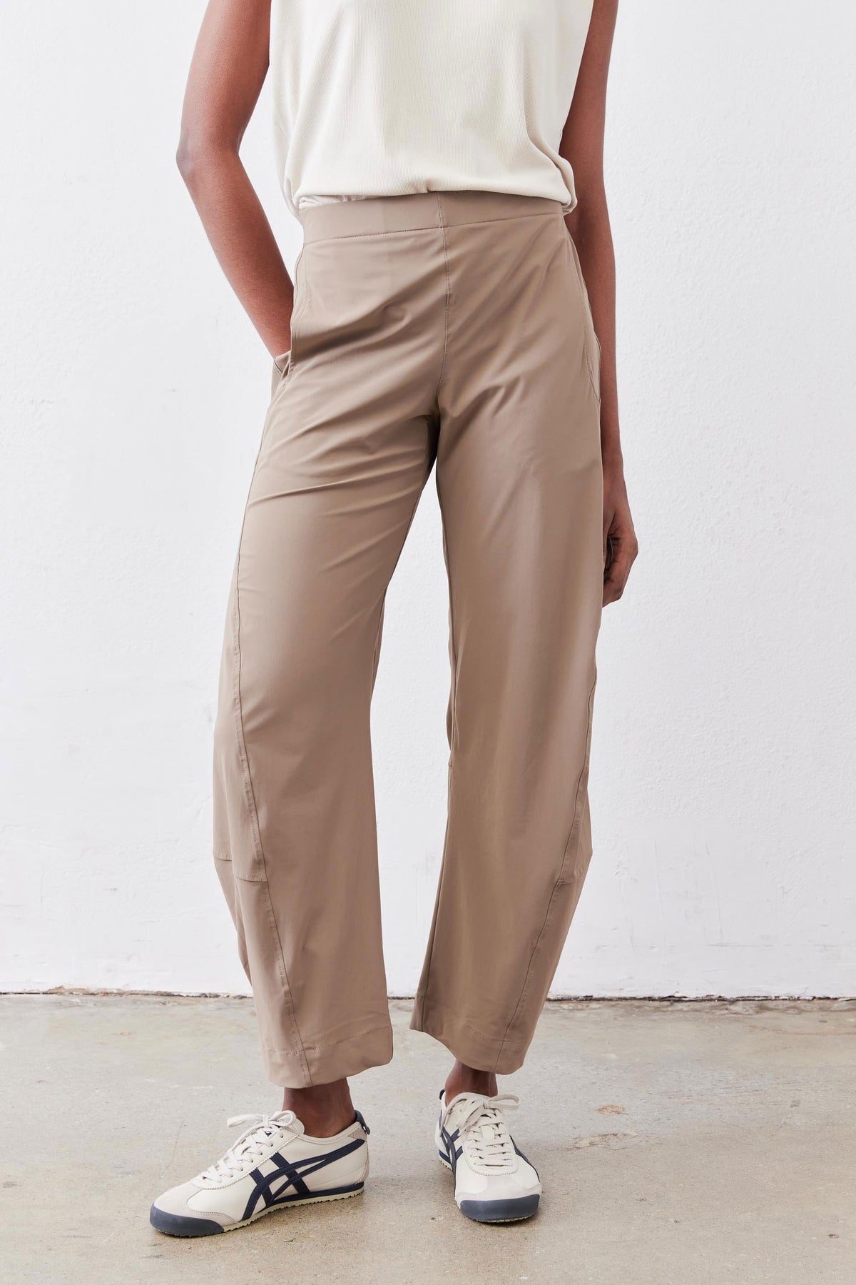 Tan work pants close-up showing relaxed fit, elastic waistband, and tapered leg