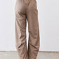 Tan loose work pants front view; elastic waistband and wide-to-tapered legs