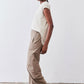 Tan relaxed work pants with elastic waist, tapered ankle hem, and side pockets