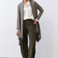 Sea gray open-knit cardigan with long sleeves and draped front over dark pants