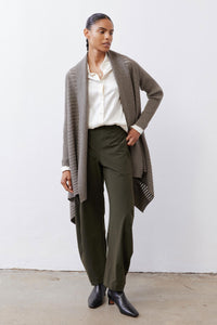 Sea gray open-knit cardigan with long sleeves and draped front over dark pants