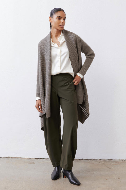 Sea gray open-knit cardigan with long sleeves and draped front over dark pants
