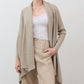 Open knit cardigan in light beige, front view with draped lapels and long sleeves