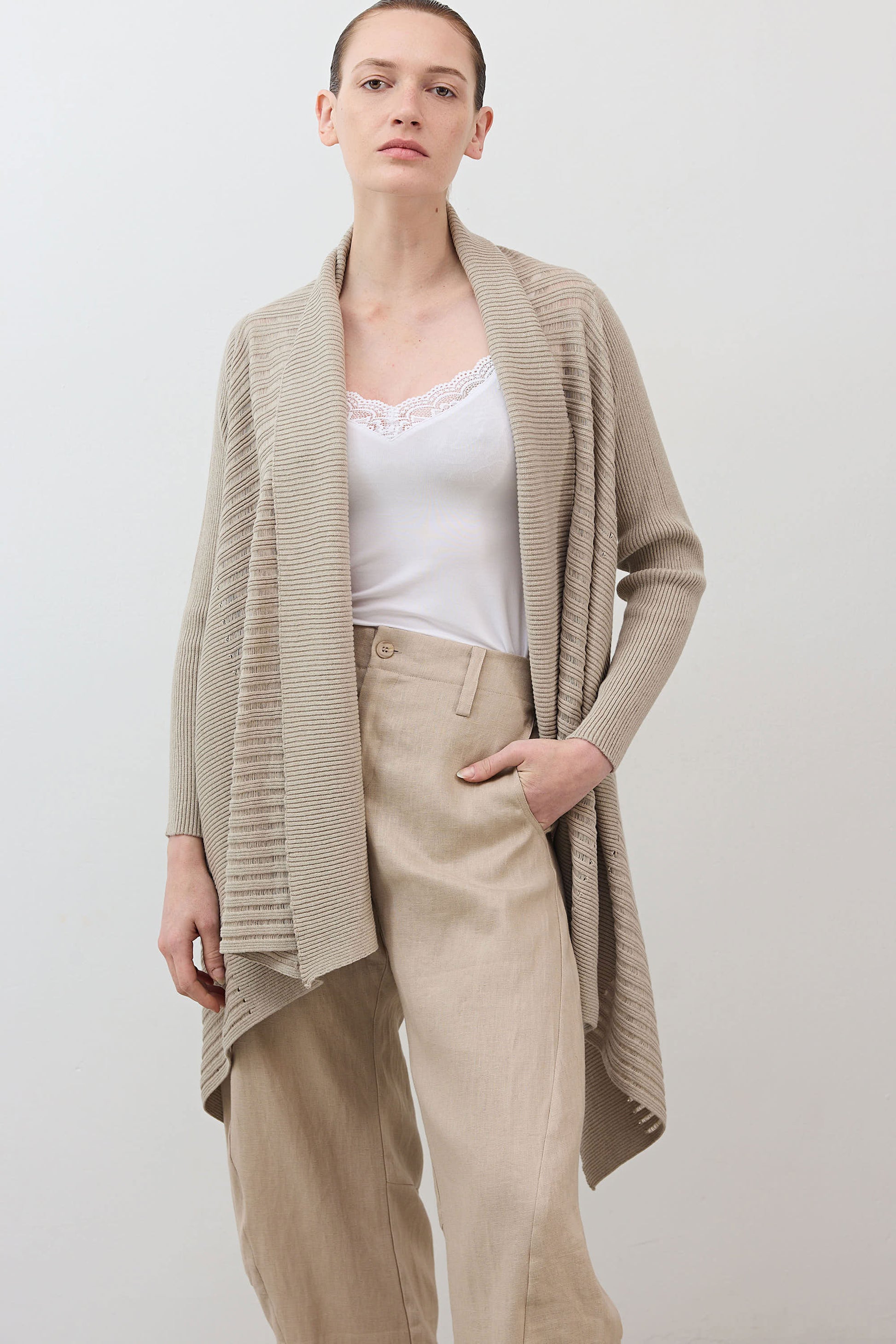 Open knit cardigan in light beige, front view with draped lapels and long sleeves