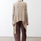 Light beige open knit cardigan shown from the back, long sleeves, draped hem