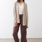 Open knit cardigan in light beige with open front and long sleeves, relaxed drape