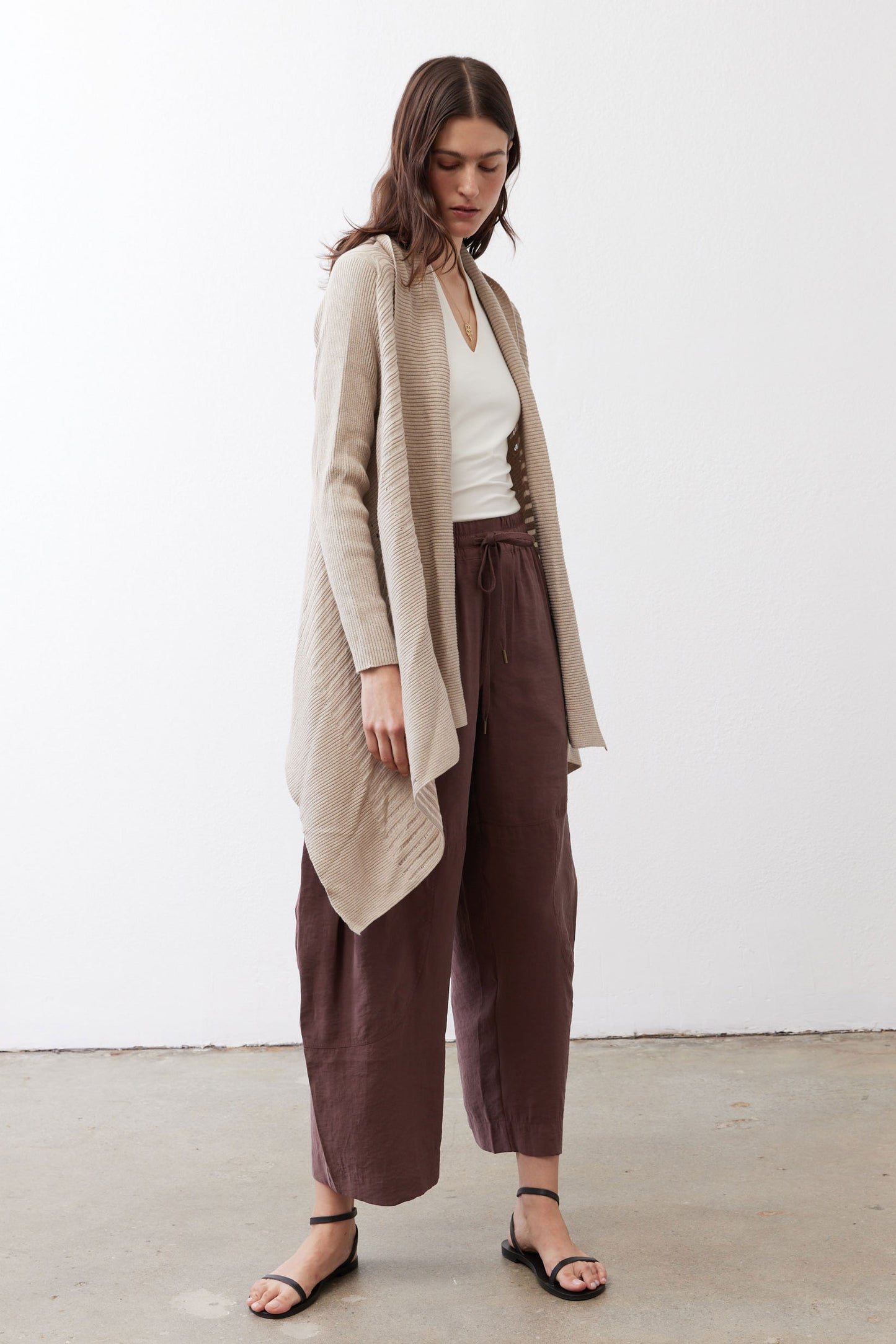Open knit cardigan in light beige, open front and asymmetric draped hem