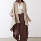 Light beige open knit cardigan with open front, long sleeves, and draped hem