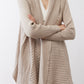 Light beige open knit cardigan with textured stripes and draped open front