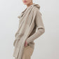 Open knit cardigan in light beige with draped front and long sleeves, angled view