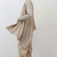 Open knit cardigan in light beige with draped front and wide hem, side view