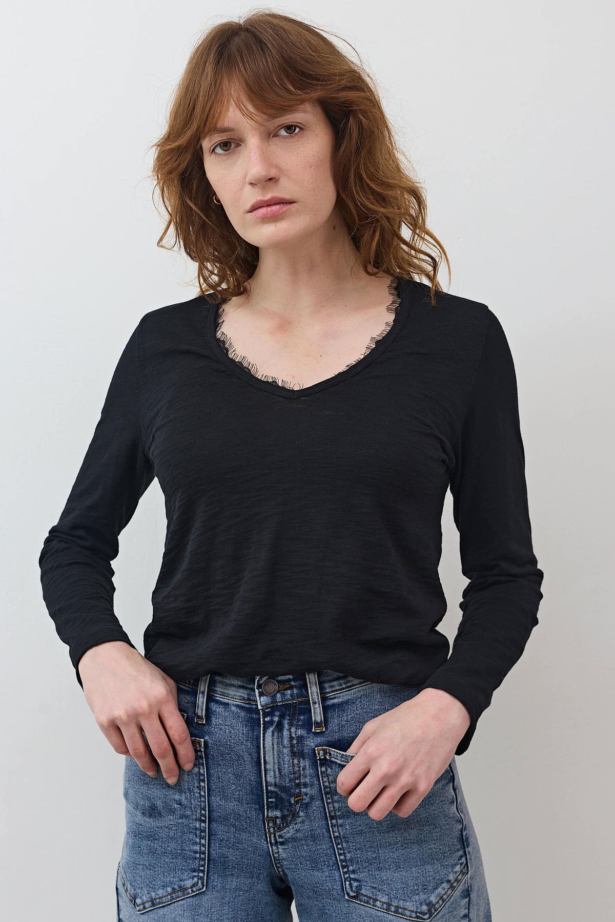 Black lace-trim V-neck long-sleeve top with gathered lace neckline detail
