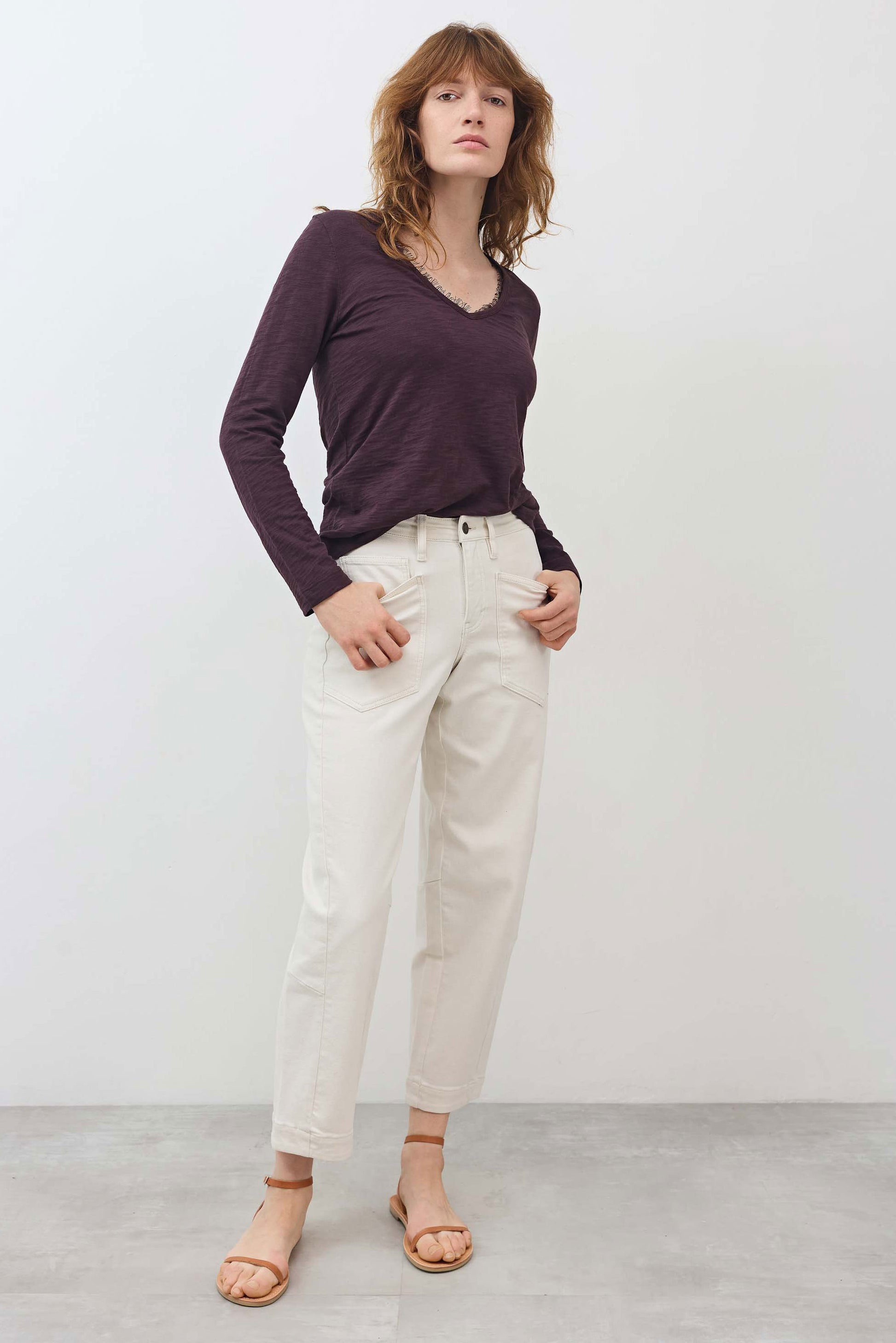 Lace-trim V-neck long sleeve top in dark plum, worn with light jeans