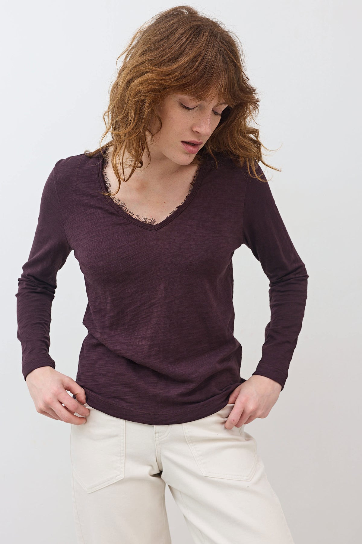Burgundy long-sleeve V-neck lace-trim top with relaxed fit