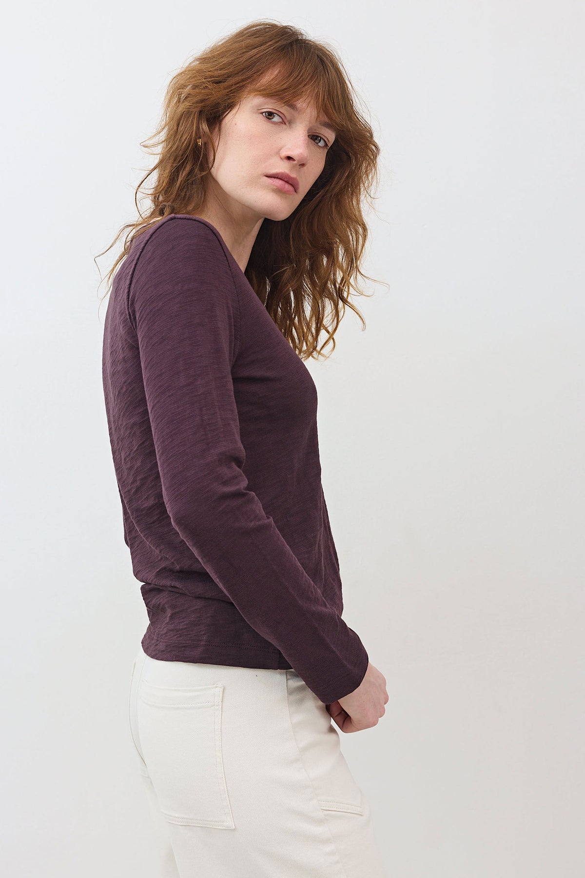 Burgundy long-sleeve V-neck lace-trim top, side view