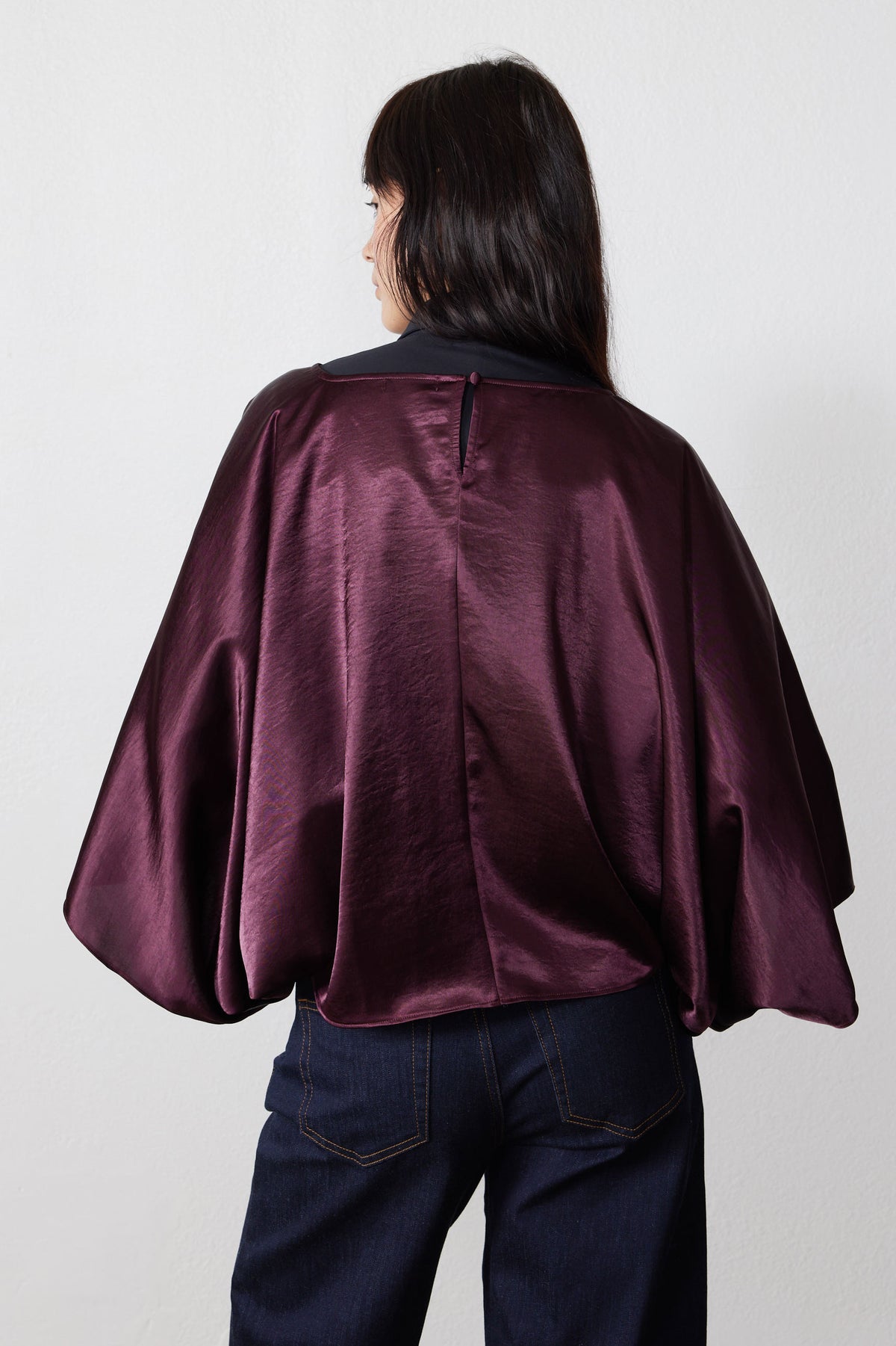 Midnight plum oversized flowy top back view with center seam and wide draped sleeves