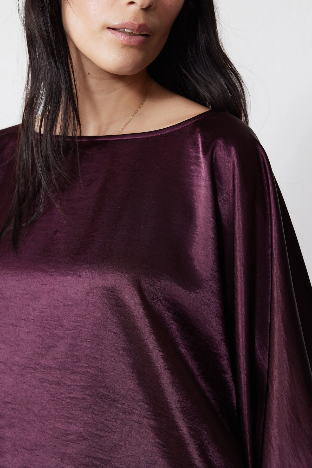 Midnight plum oversized top close-up with satin sheen and wide neckline