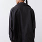 Black oversized nylon trench back view with roomy shoulders and side seam detail.