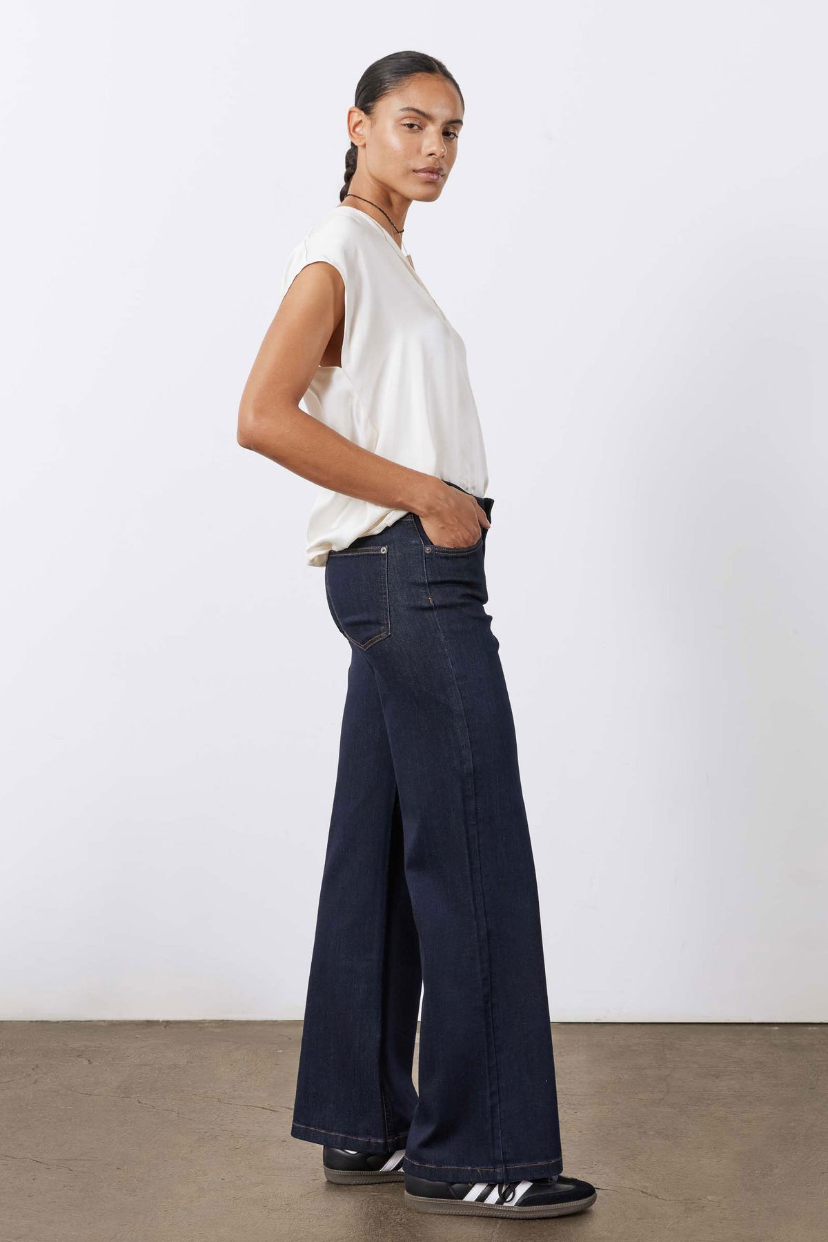 Women's palazzo jeans in dark blue wash, side view with high waist and wide straight legs