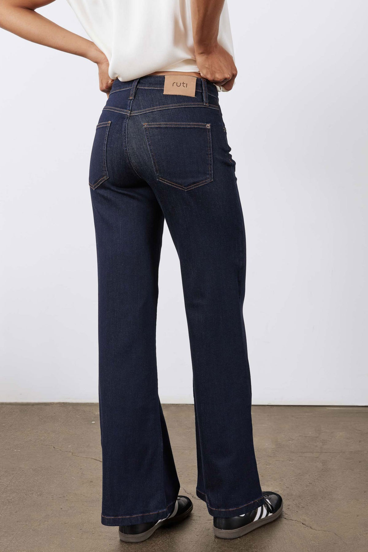 Dark blue palazzo jeans with high waist, belt loops, and wide flared legs
