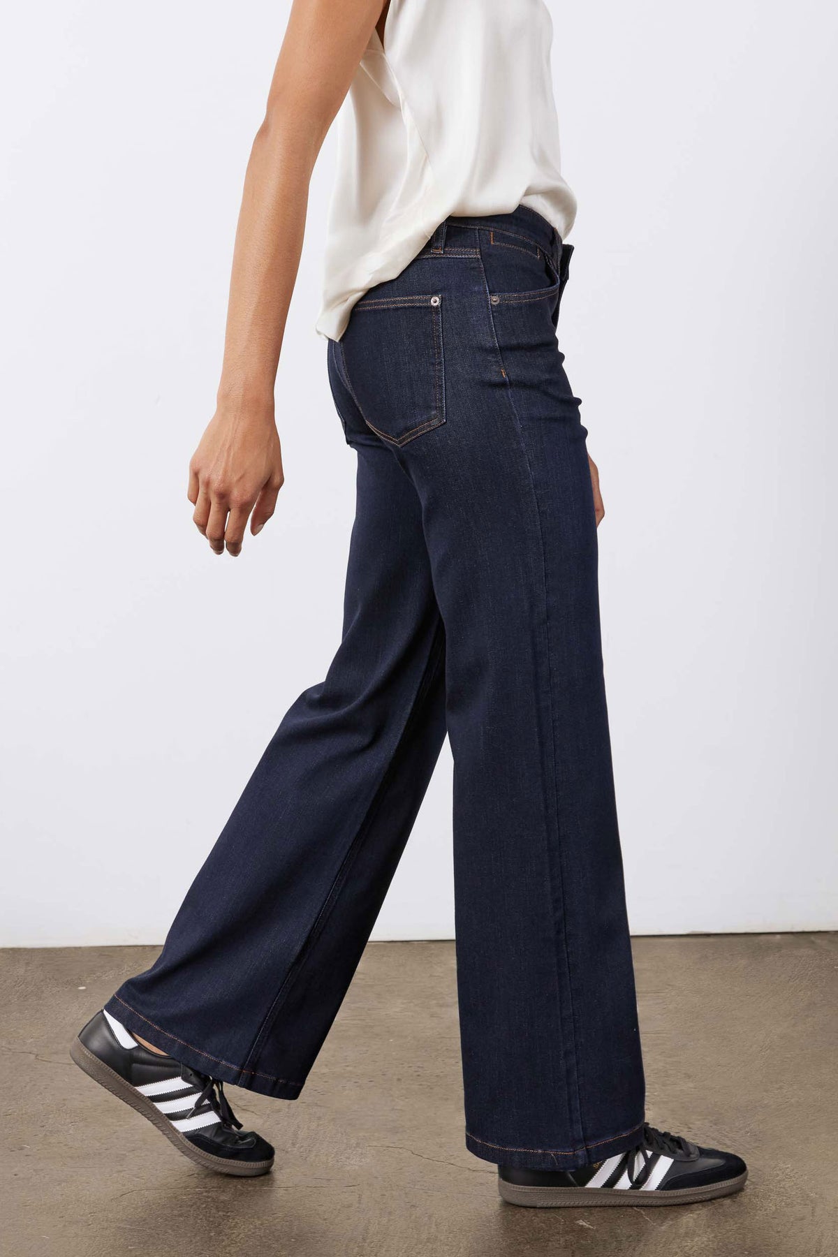 Dark blue palazzo jeans side view showing deep front pockets and wide leg opening