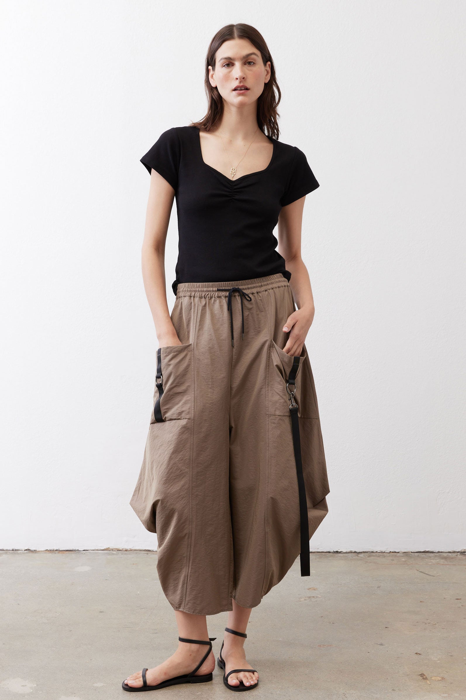 Black square-neck short-sleeve top, fitted with ruched neckline