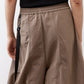 Walnut brown gathered waist pants with adjustable drawstring and oversized side pockets