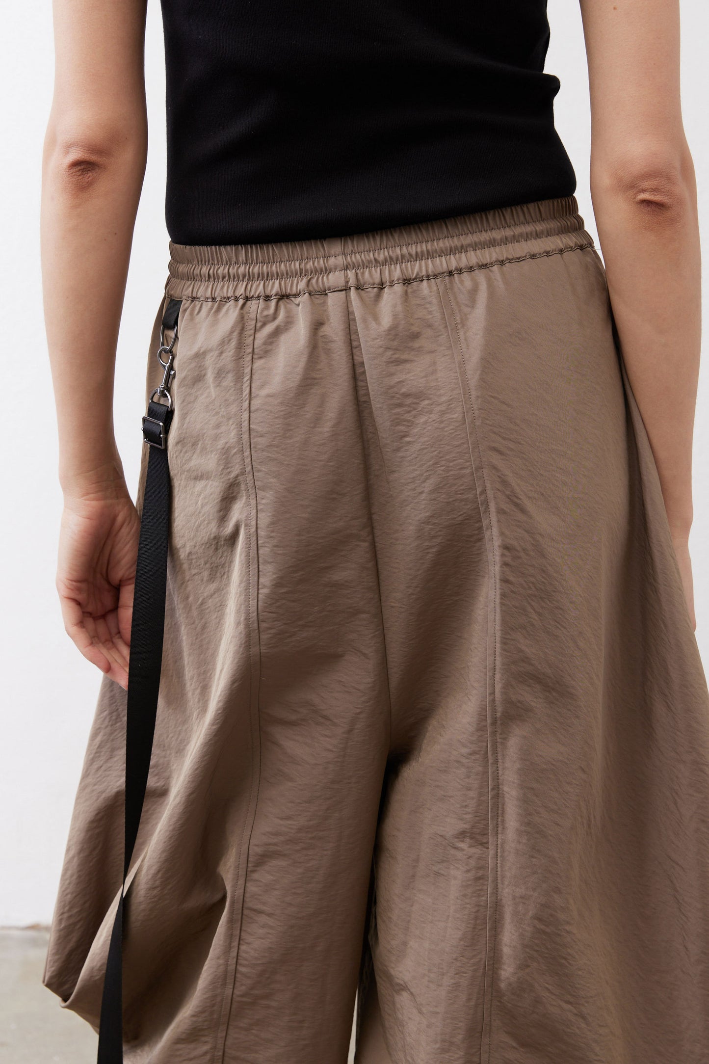 Walnut brown gathered waist pants with adjustable drawstring and oversized side pockets