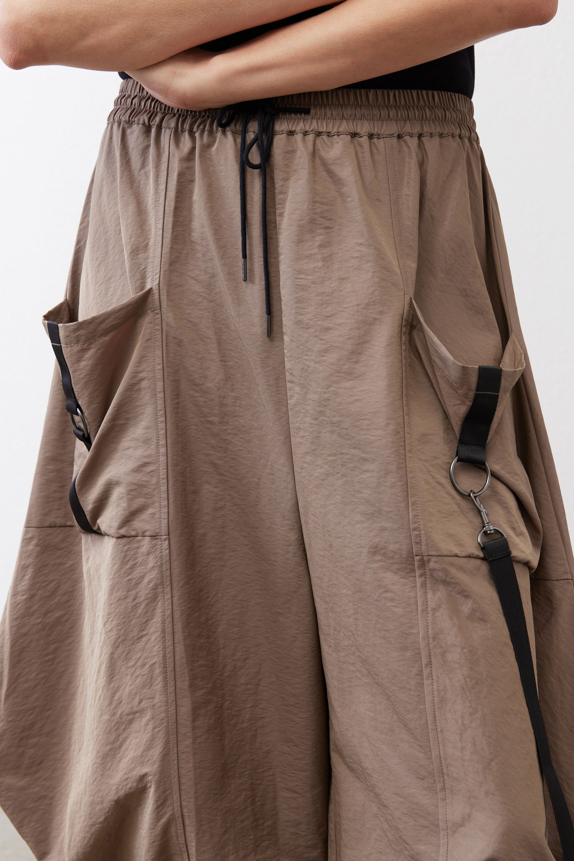Walnut brown wide-leg pants with gathered elastic waist and side pocket flaps