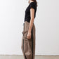 Walnut brown wide-leg pants shown from the side, elastic waist and cargo pocket detail