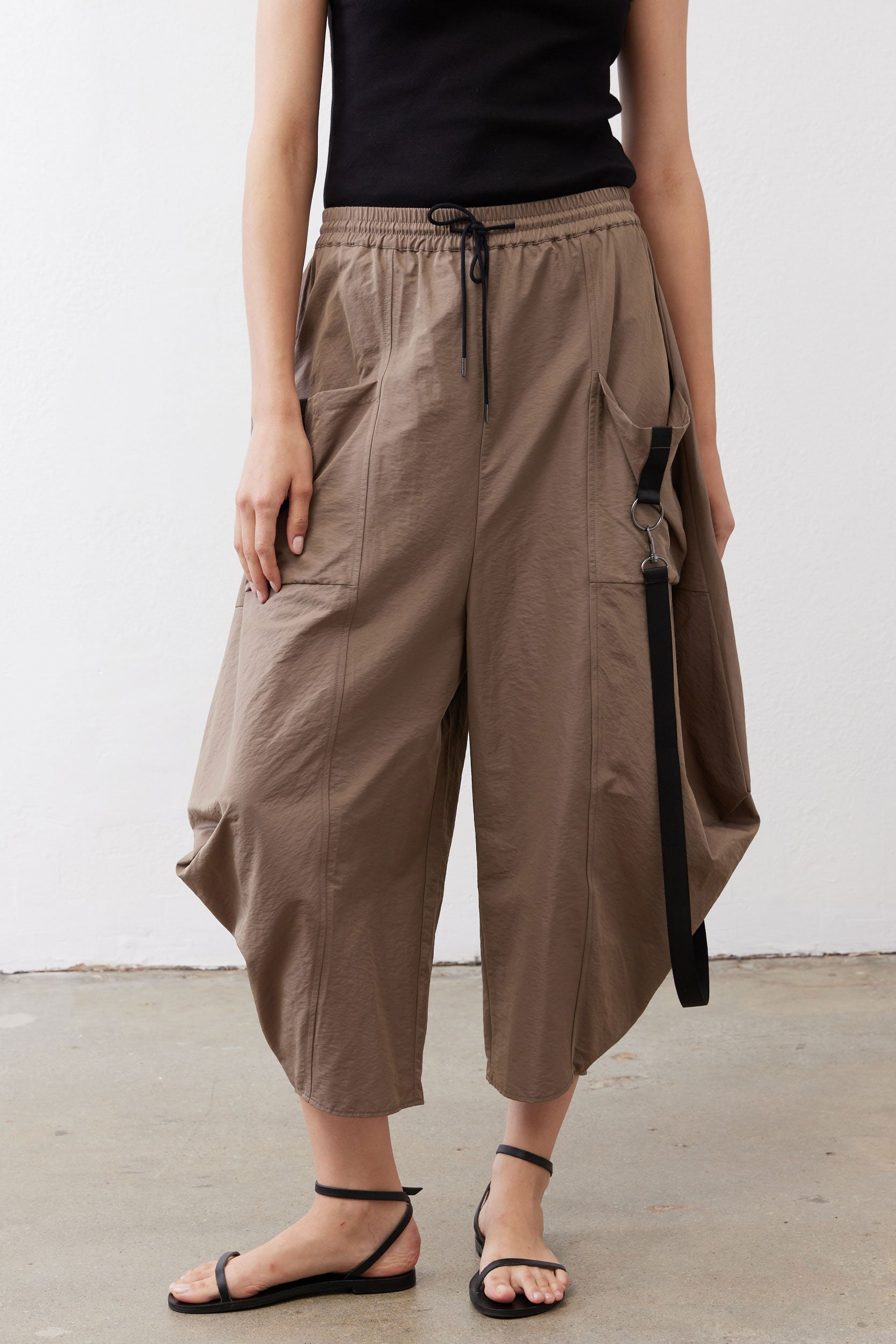 Walnut brown wide-leg pants with elastic waistband and black drawstring, cropped