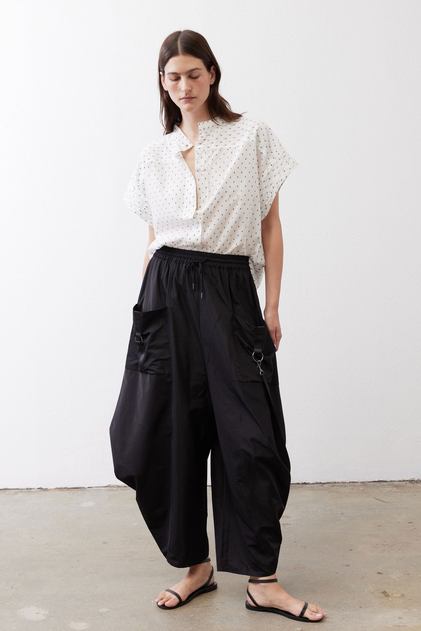 Black parachute wide-leg pants with drawstring waist and cargo pockets