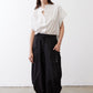 Black parachute wide-leg pants with drawstring waist, roomy legs, and side loops.