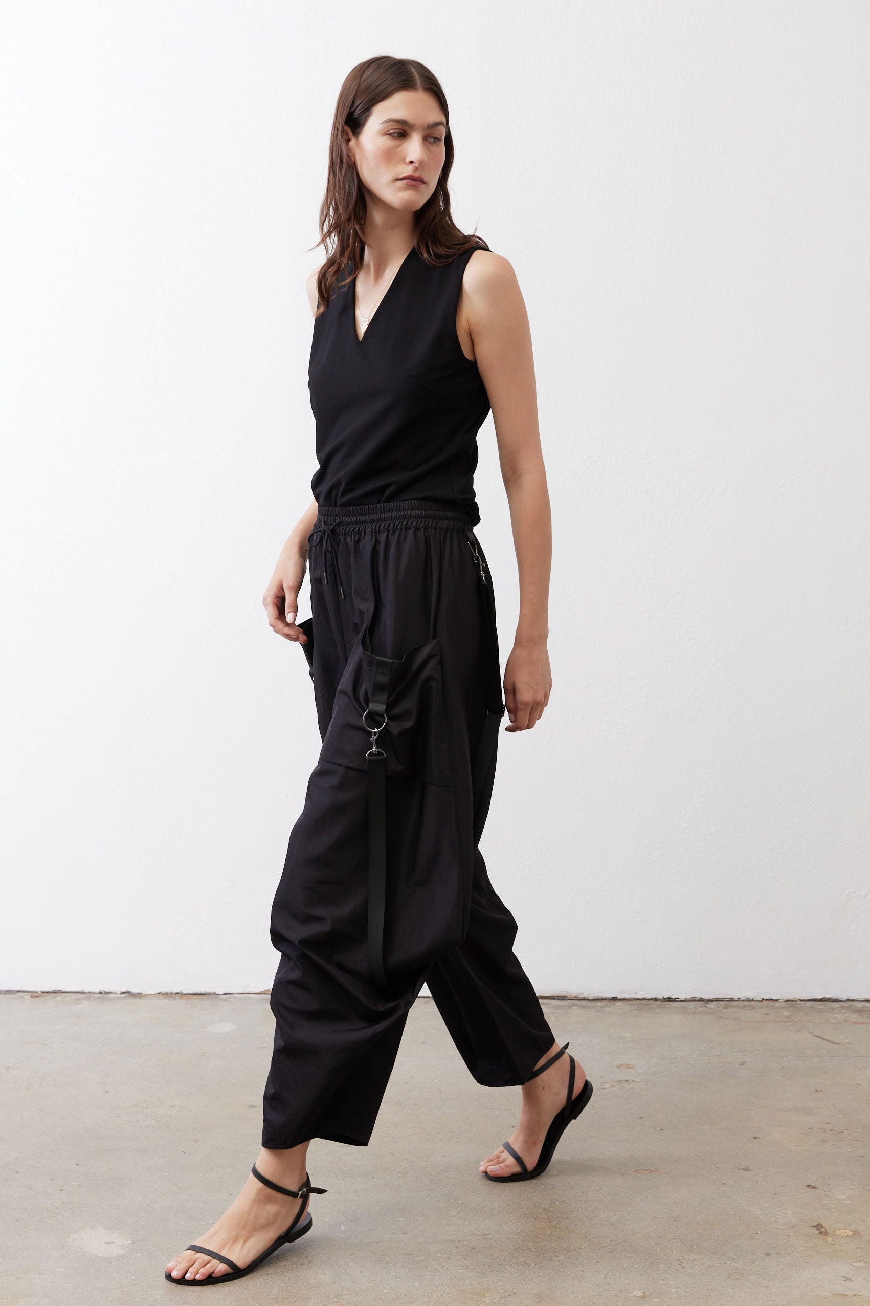 Black wide-leg parachute pants with drawstring waist and relaxed, billowy legs.