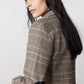 Brown plaid blazer with black elbow patch and long sleeves