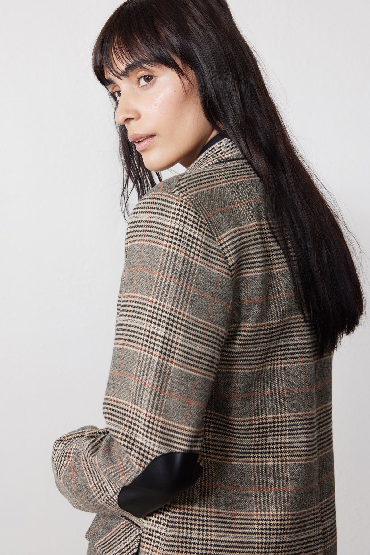 Brown plaid blazer with black elbow patch and long sleeves