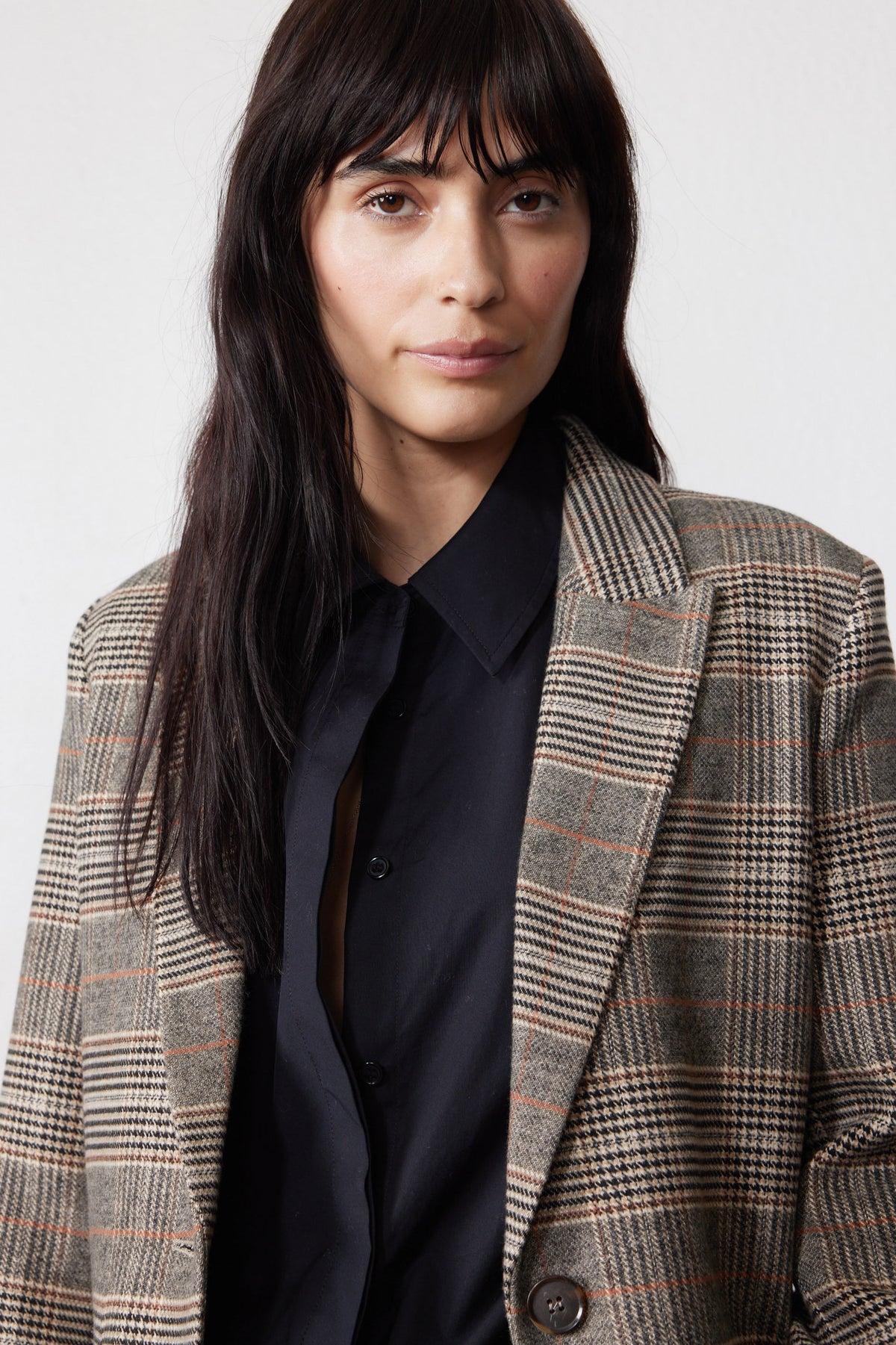 Brown plaid blazer with black elbow patches and chest pocket detail