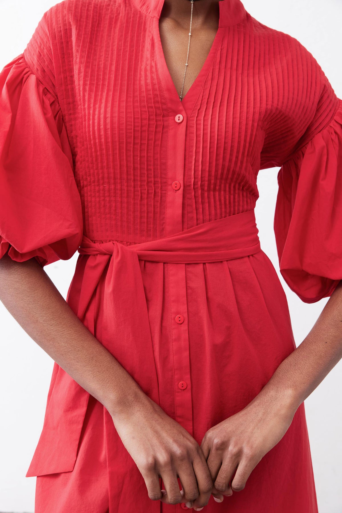 Crimson pintuck poplin V-neck dress with gathered sleeves and tie waist detail