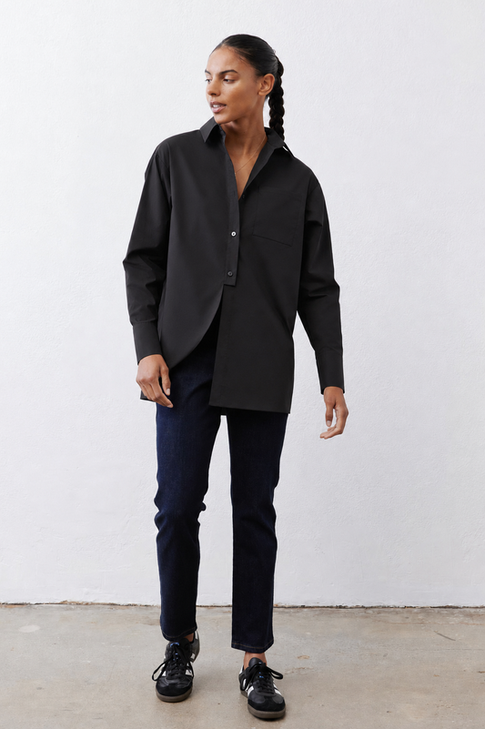 Black asymmetric button-down shirt with chest pocket, pointed collar, long sleeves.