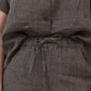 Charcoal pinstripe linen pants with tied drawstring at elastic waistband